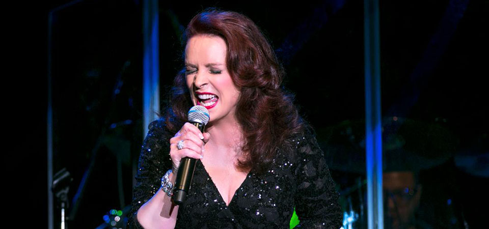 Sheena Easton singing in microphone