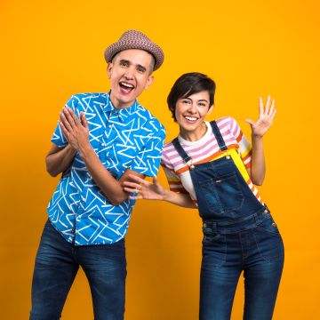 man and woman in front of yellow background