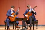 two students playing guitar