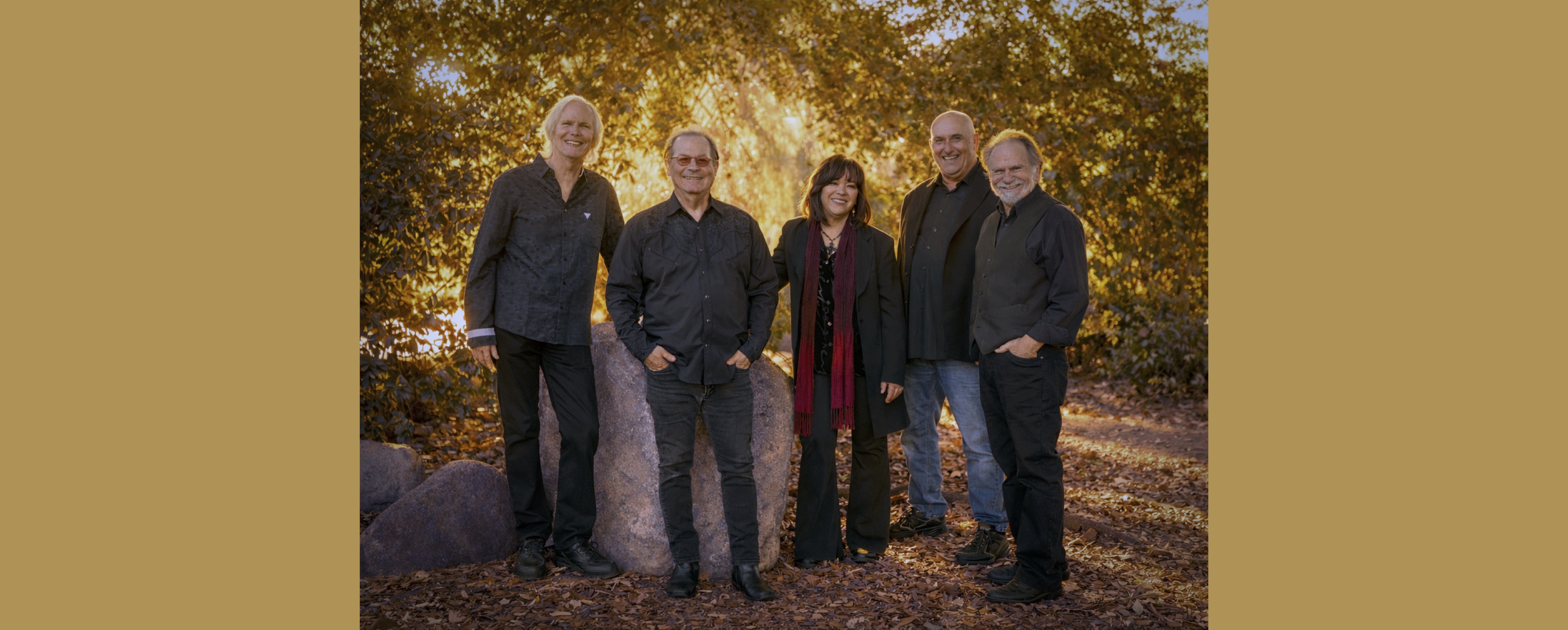 Image of five band members in a forest