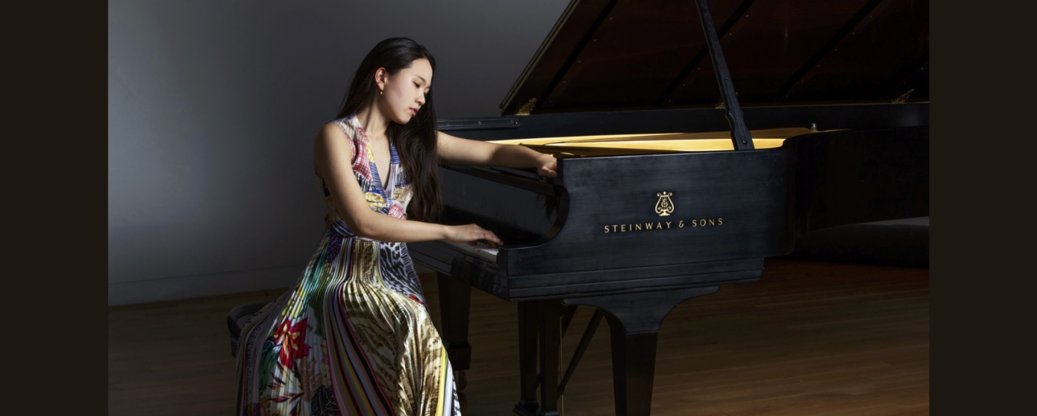 Image of Chaeyoung Park seated beside a piano