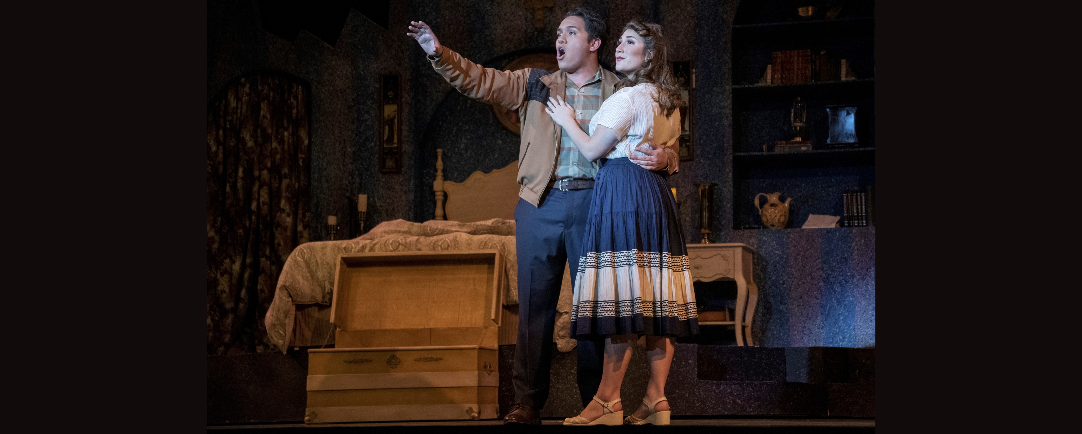 Image of two lovers standing beside an open chest in a bedroom