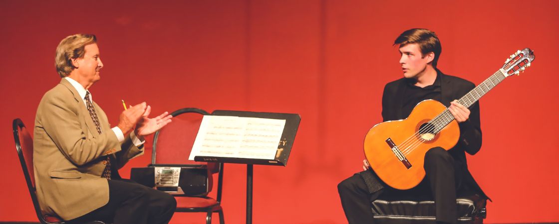 Image of Christopher Parkening instructing a guitar student