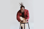 Okaidja Afroso drumming on a stool