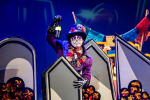 Image of man in sugar skull makeup and a suit and hat holding a lantern