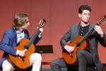 Image of two students playing guitar